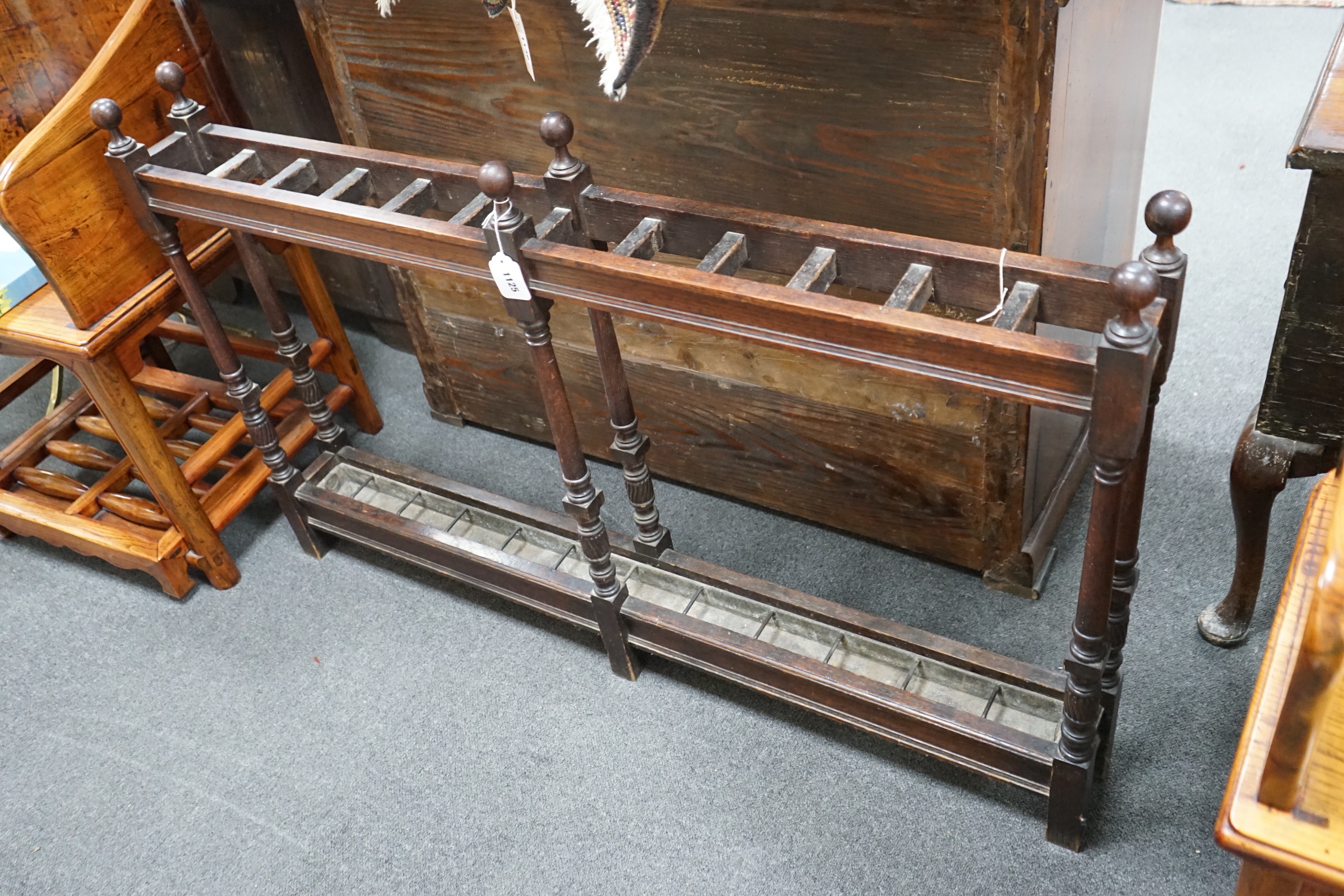 A large Victorian oak club stickstand, with zinc drip trays, width 122cm, depth 14cm, height 77cm